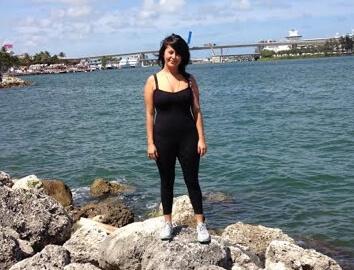 Picture of a woman wearing black in front of a river