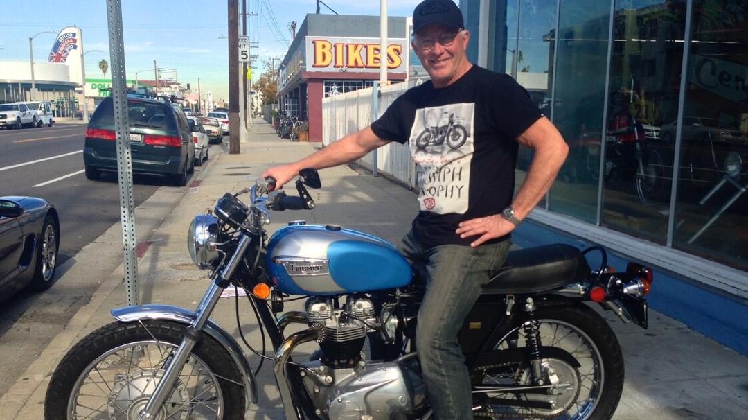Man sitting on parked motorcycle